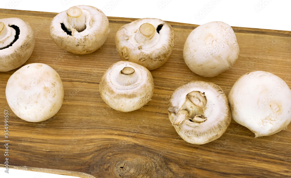 champignons on a wooden board on white