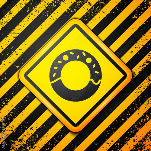 Black Donut with sweet glaze icon isolated on yellow background. Warning sign. Vector Illustration