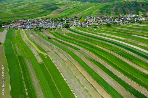 Poland from above. Aerial view of green agricultural fields and village. Landscape with fields of Poland. Typical polish landscape.