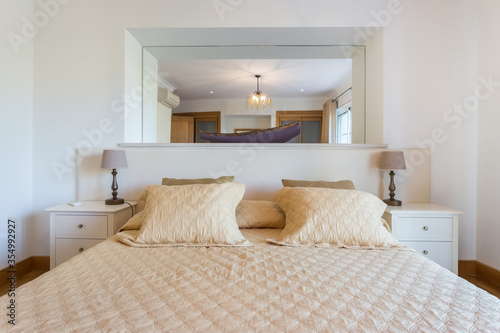 Beautiful modern bedroom with a large mirror on the wall. European hotel design. Close-up.