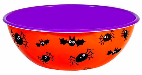 Empty orange and purple Halloween candy bowl with bat and spider accents. Isolated.
