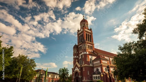 A time-lapse of evening clouds racing past the top of a Cathedral of Saint John the Evangelist, just before sunset in Lafayette, Louisiana. photo