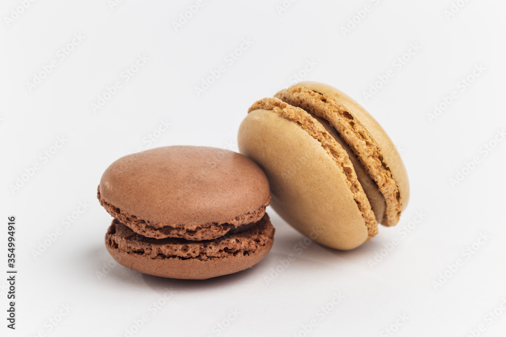 Brown and beige macarons on white background Brown and beige macarons on white background