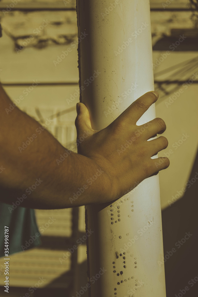 hand of a young boy holding a white tube