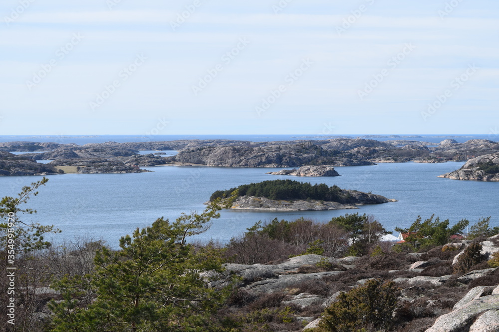 Lake with a small island next to the sea on a mountain in Fjällbacka, Sweden
