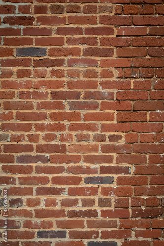 Tall brick wall background, vintage weathered brick partially repointed, creative copy space, vertical aspect