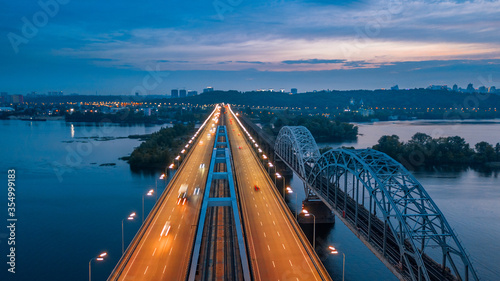 aerial night city view, luminous buildings and bridge. Drone shot.