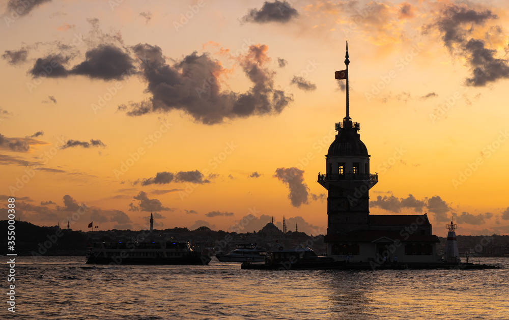 Cityscape of historic Istanbul with the silhouette of famous Maiden's/Leander's Tower with cruising ferryboats during the colorful sunset. Üsküdar, Istanbul, Turkey