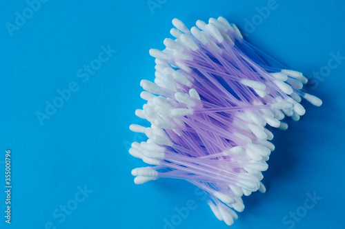 Cotton buds for medical on color background. Round container with cotton buds.