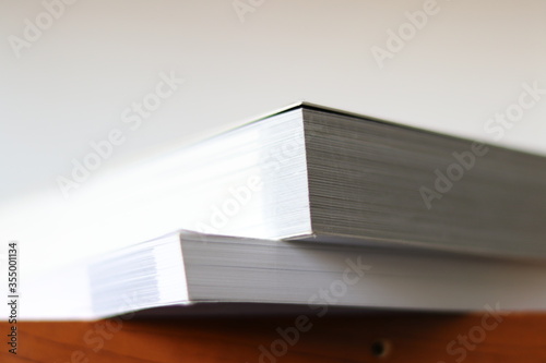 Books, Thick heavy books with white paper and hard cover, good binding, perfect binding, large number of pages, huge page booklet on table