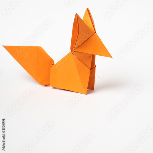 origami red fox on a white background photo