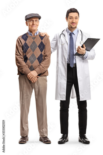 Young male doctor standing next to an elderly patient