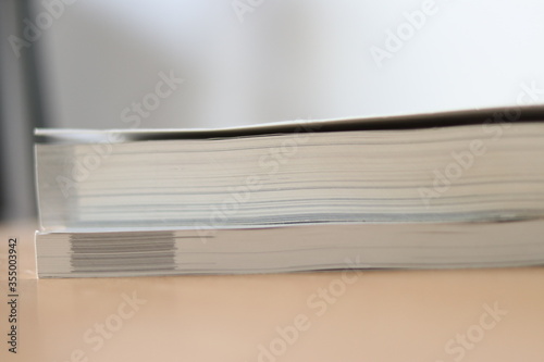 Books, Thick heavy books with white paper and hard cover, good binding, perfect binding, large number of pages, huge page booklet on table