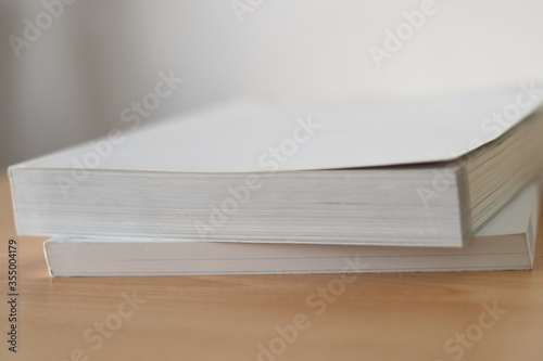 Books, Thick heavy books with white paper and hard cover, good binding, perfect binding, large number of pages, huge page booklet on table