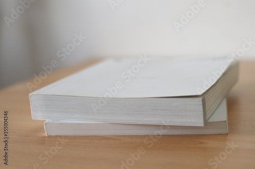Books, Thick heavy books with white paper and hard cover, good binding, perfect binding, large number of pages, huge page booklet on table