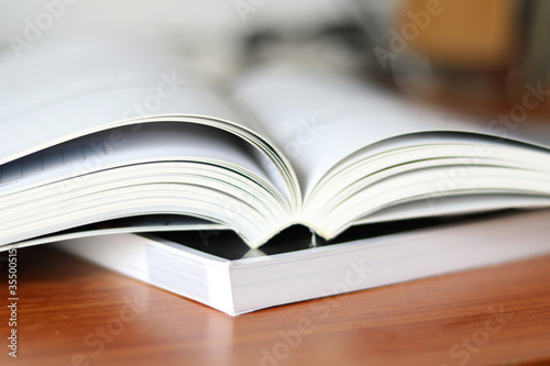 Books, Thick heavy books with white paper and hard cover, good binding, perfect binding, large number of pages, huge page booklet on table