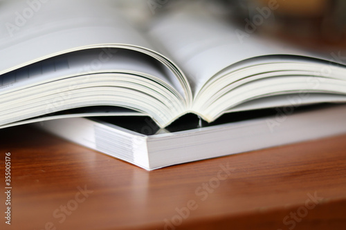 Books  Thick heavy books with white paper and hard cover  good binding  perfect binding  large number of pages  huge page booklet on table