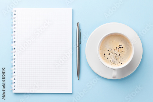 Office workplace desk table with notepad and coffee
