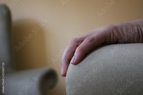 mental health therapy concept hand on armchair as talking to another causes lonely sad depression PTSD or many other cause background with copy space 