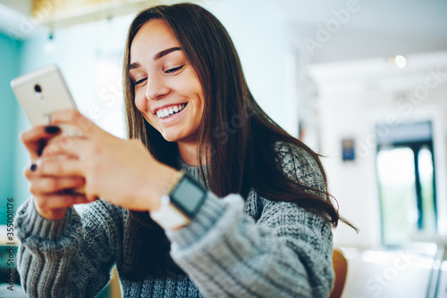 Emotional hipster girl surprised with winning online contest talking with operator on mobile phone