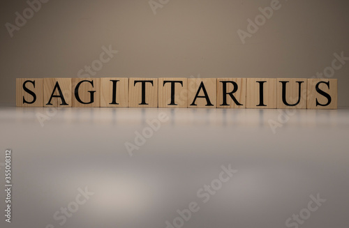 Sagittarius word on wooden cubes on white background.