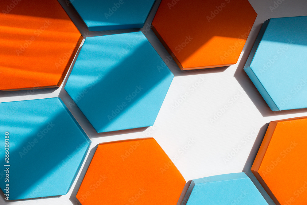 A close up beautiful blue, orange and hexagon boxes of present on the white background. Place for text. Empty centre. Top view. Flat lay. A close up beautiful blue, orange and hexagon boxes of present on the white background. Place for text. Empty centre. Top view. Flat lay.