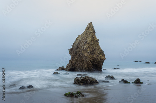 sea stack on beach  in gloomy weather