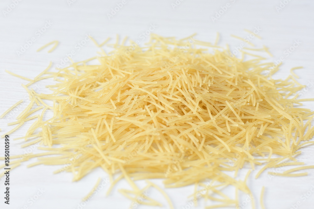 Short pasta spaghetti angel hair displayed in containers on white background Short pasta spaghetti angel hair displayed in containers on white background