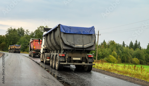 Bulldozer, excavator and dump truck operation photo