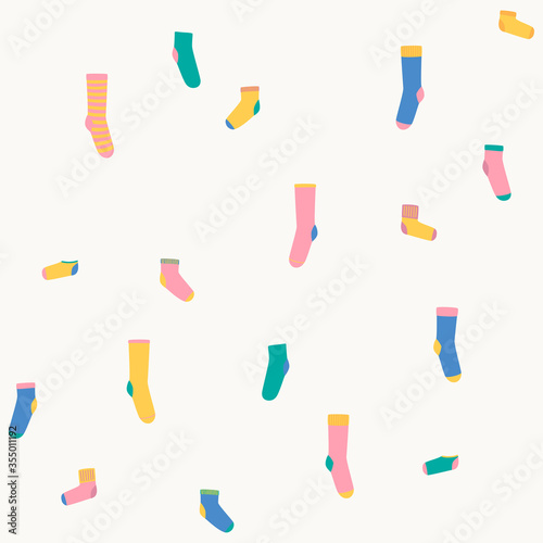 Vector illustration with randomly located colorful socks. Seamless pattern.