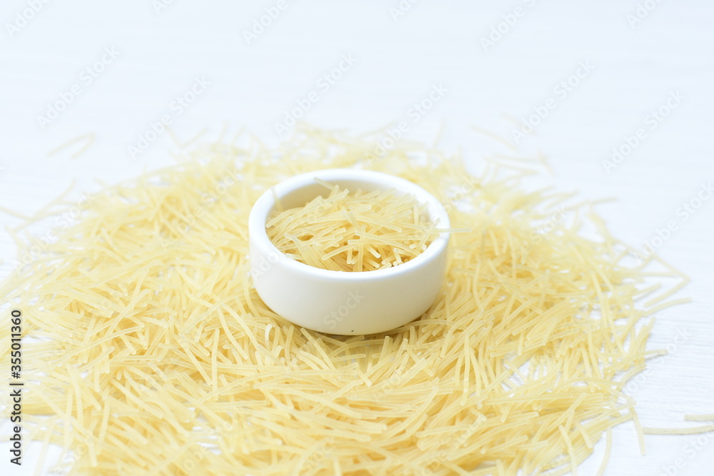 Short pasta spaghetti angel hair displayed in containers on white background Short pasta spaghetti angel hair displayed in containers on white background