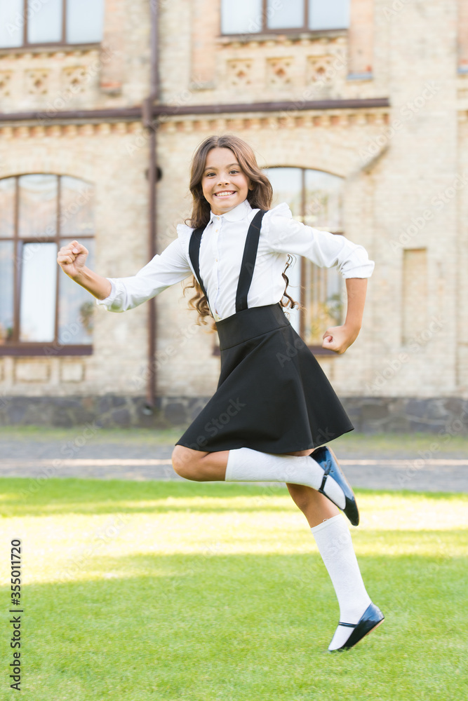 small student girl run towards knowledge. back to school. little girl looking smart and intelligent. happy schoolgirl in stylish uniform. childhood happiness. hurry up, its last kid fashion sale