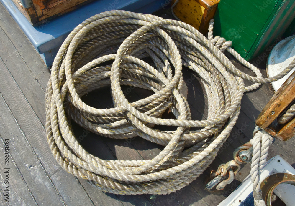 Traditional ropework on an old sailing ship designed to keep the deck safe and orderly.  Closeup.