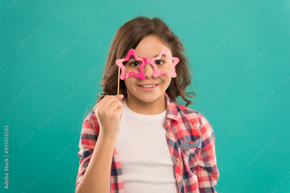 Celebration. Happy little child. Party decorations. Party shop. Start this party. Hey just have fun. Funny small girl holding glasses photo booth props on stick. Cute kid with fancy party props