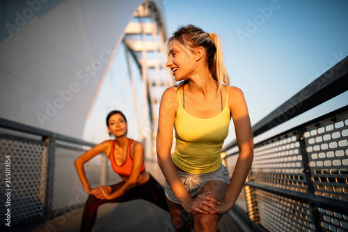 Fototapeta Naklejka Na Ścianę i Meble -  Beautiful women working out in a city. Running, jogging, exercise, people, sport concept