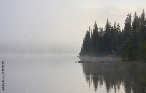 Morning fog in Pyramid Lake with canoes in Canada