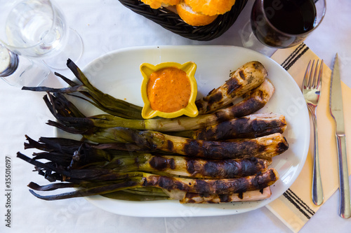 Top view of grilled calcots with romesco sauce photo