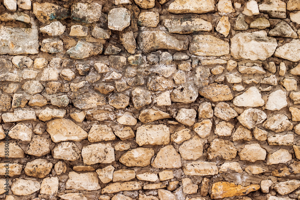 Part of a stone wall for background or texture. Rough masonry. Part of a stone wall for background or texture. Rough masonry.