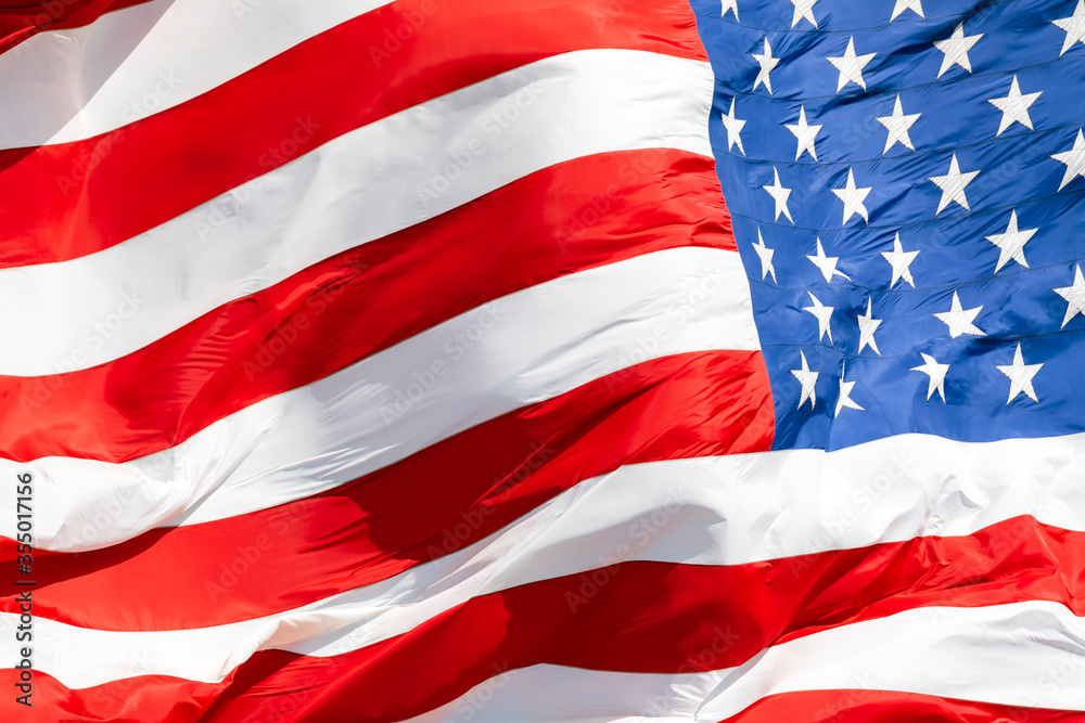 American flag waving in the wind, US flag motion close-up, United States of America national flag. USA stars and stripes American flag waving in the wind, US flag motion close-up, United States of America national flag. USA stars and stripes
