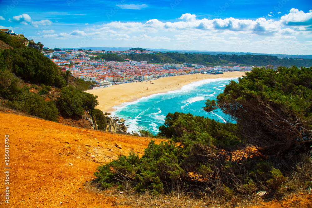 View of Nazare town and the sandy beach seen from high cliff, Portugal