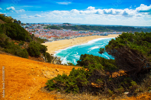 View of Nazare town and the sandy beach seen from high cliff, Portugal