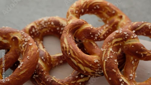 Oktoberfest food menu, soft pretzels and beer on a wooden board and white background. Beer is poured. Misted glass with beer.