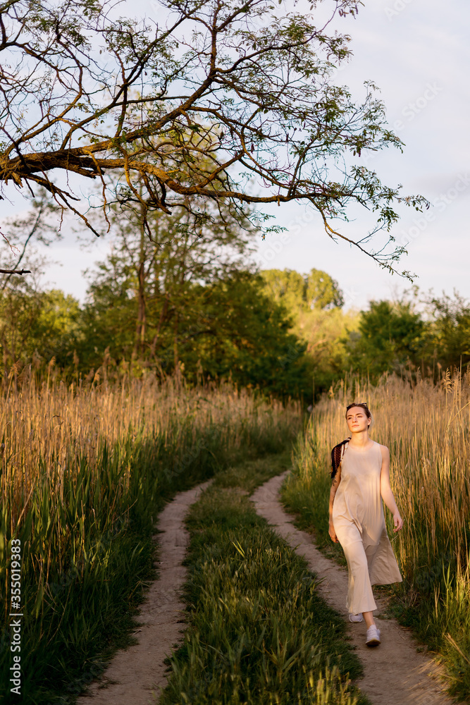 Joyful young woman relaxing during her weekend walking in nature on a beautiful day Joyful young woman relaxing during her weekend walking in nature on a beautiful day