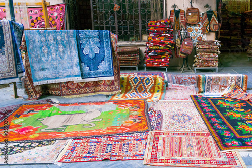 colors of oriental bazaar with souvenirs, bright motley fabrics and carpets are hung out for sale