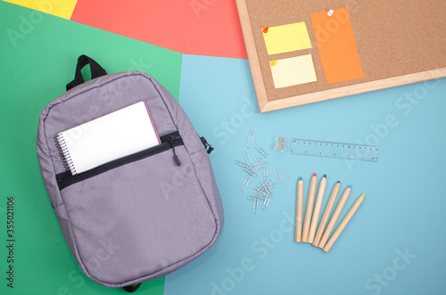 Backpack and school accessories with colored backgrounds and space to put text.
