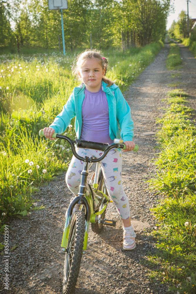 teenage girl on a bicycle with hand up teenage girl on a bicycle with hand up