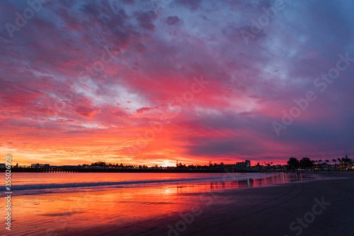 Incredible red sunset in Santa Cruz. Red sky on the beach in California 