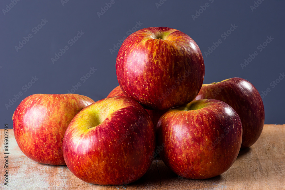 .Some apples in a basket in the background. Wood background .Some apples in a basket in the background. Wood background