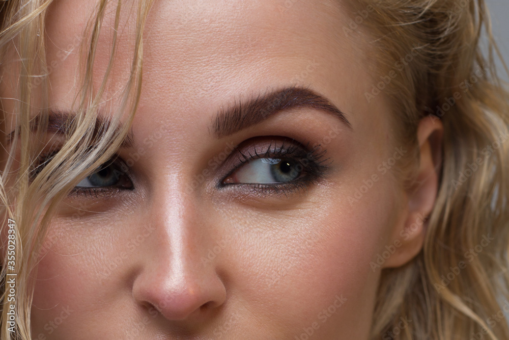 Elegance close-up female eye with dark brown eyeshadow. Macro shot of part of the face of a beautiful woman. Wellness, cosmetics and makeup. smooth beautiful eyebrows and eyelashes Elegance close-up female eye with dark brown eyeshadow. Macro shot of part of the face of a beautiful woman. Wellness, cosmetics and makeup. smooth beautiful eyebrows and eyelashes