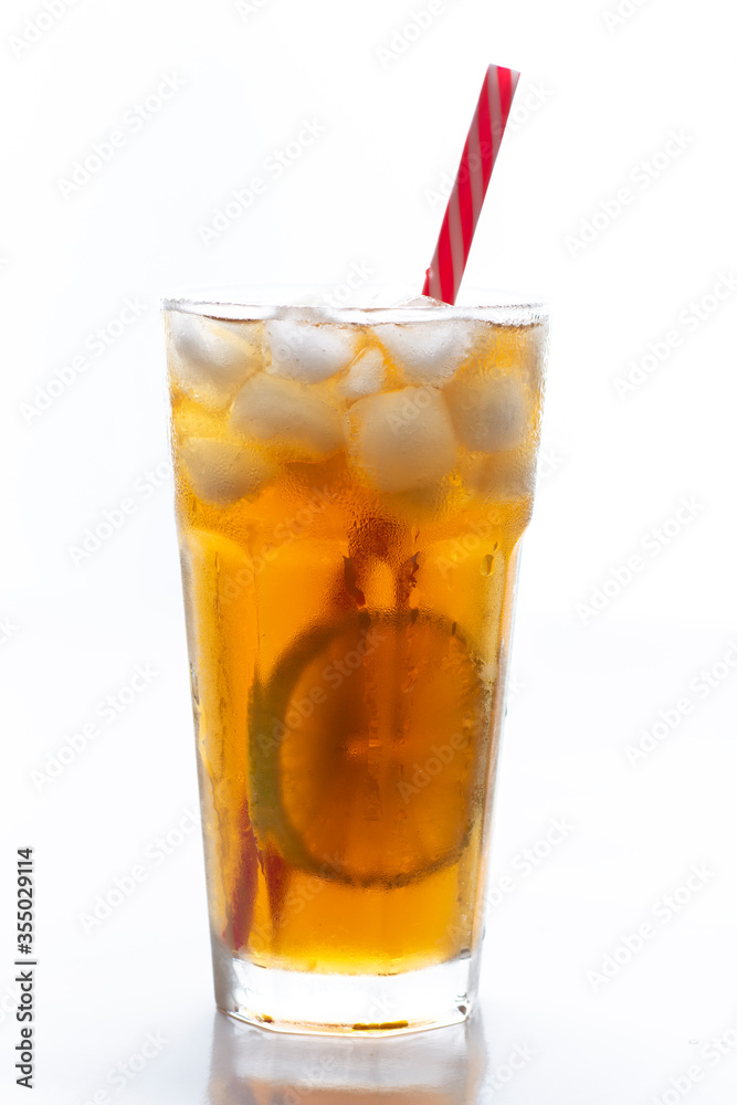 Iced tea with straw, ice cubes and sliced lemon over white background Iced tea with straw, ice cubes and sliced lemon over white background